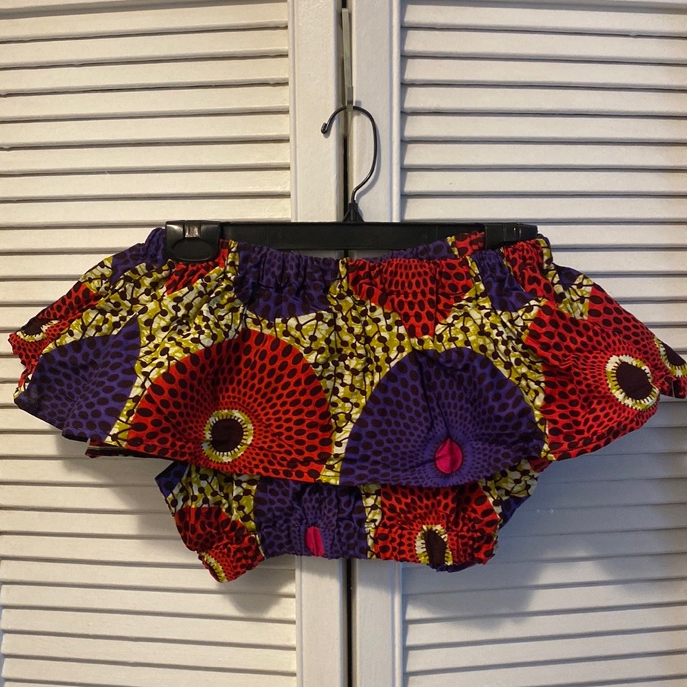 Ofuure crop top with puffed sleeves graphic print in red and purple.